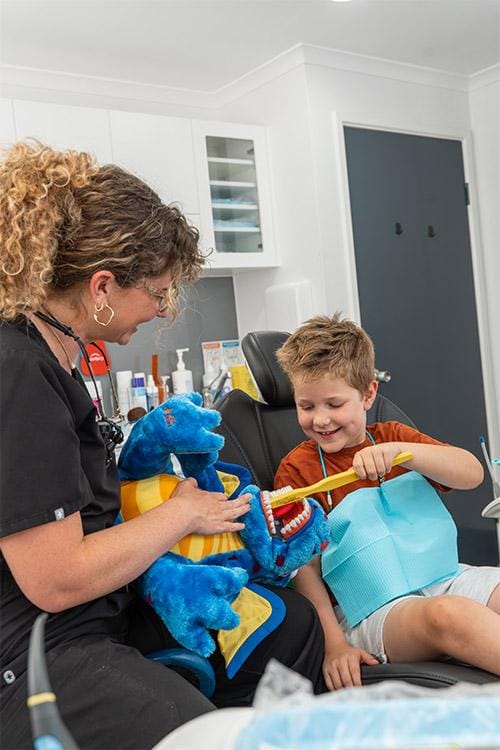 Dentist explaining how to brush teeth